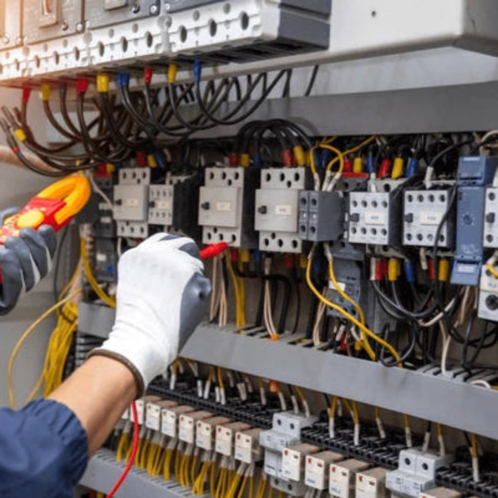 Engineer hand holding AC voltmeter checking electric current voltage at circuit breaker terminal and cable HVAC